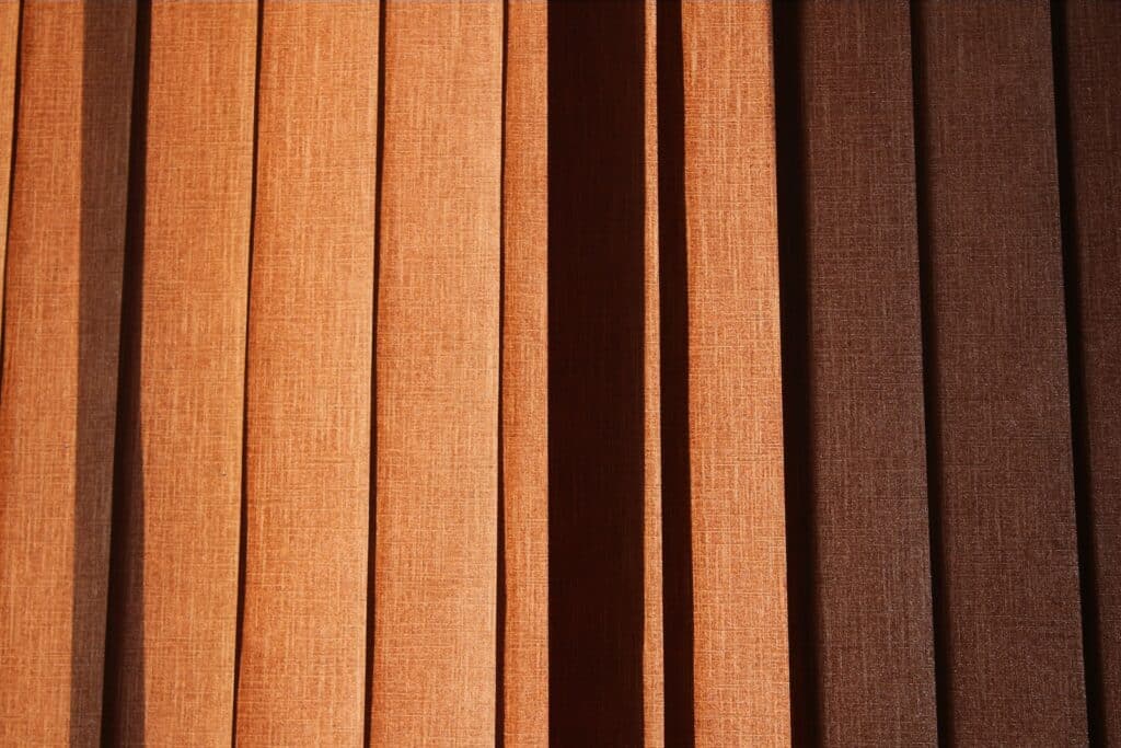 a close up of a window with brown blinds